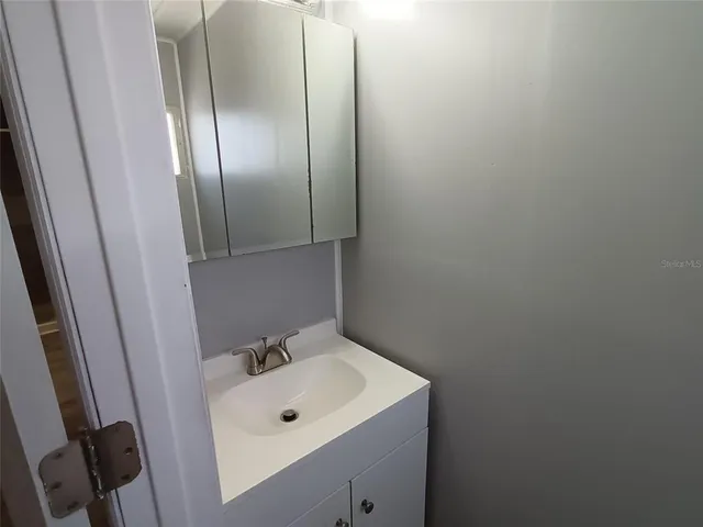 a bathroom with a sink and mirror