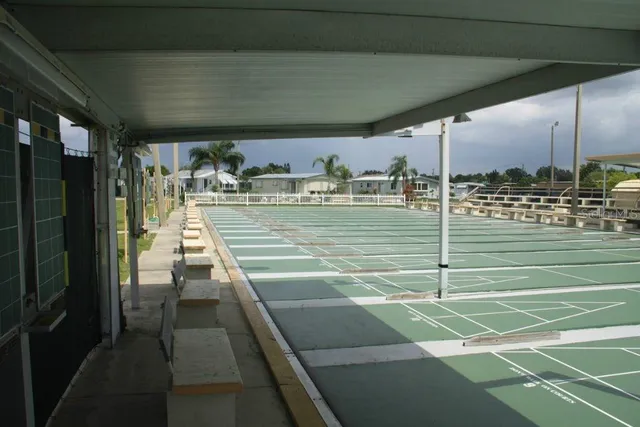 a view of a patio with table and chairs under an umbrella