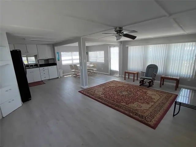 a living room with furniture rug and window