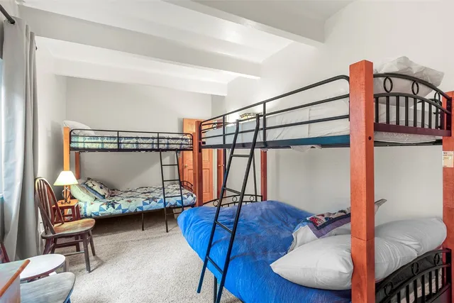 a bedroom with furniture and a air conditioner vent