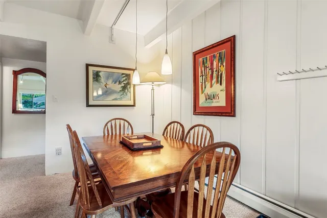 a view of a a dining room with furniture window and wooden floor