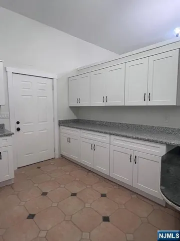 an empty room with chandelier fan