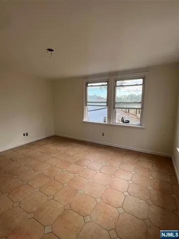 a view of an empty room with windows