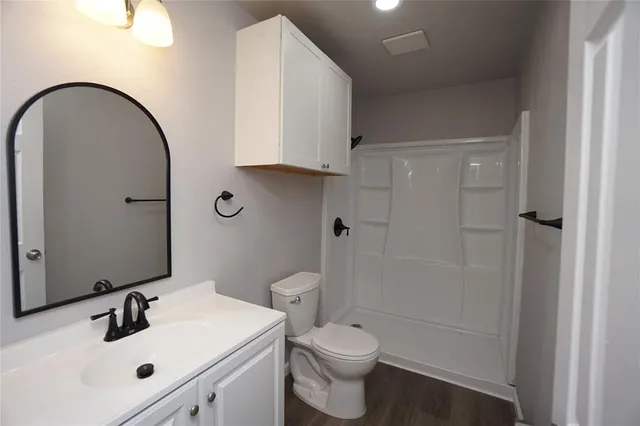 a bathroom with a sink toilet and shower