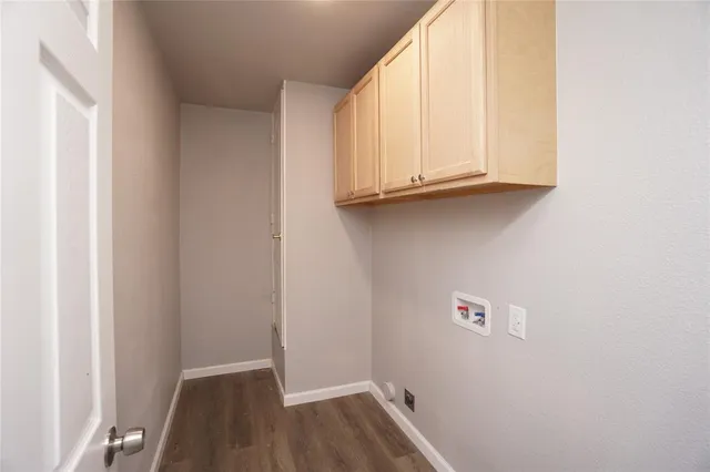 a view of storage and utility room with wooden floor