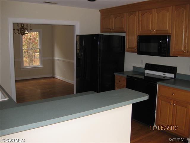 1665 Huntingdon Road Crozier, VA 23039 - Photo 3 of 6 a kitchen with a refrigerator and a microwave