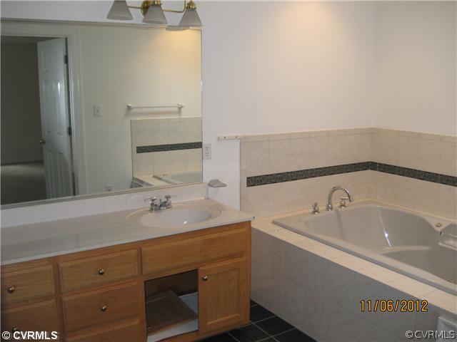1665 Huntingdon Road Crozier, VA 23039 - Photo 5 of 6 a bathroom with a sink and a bathtub