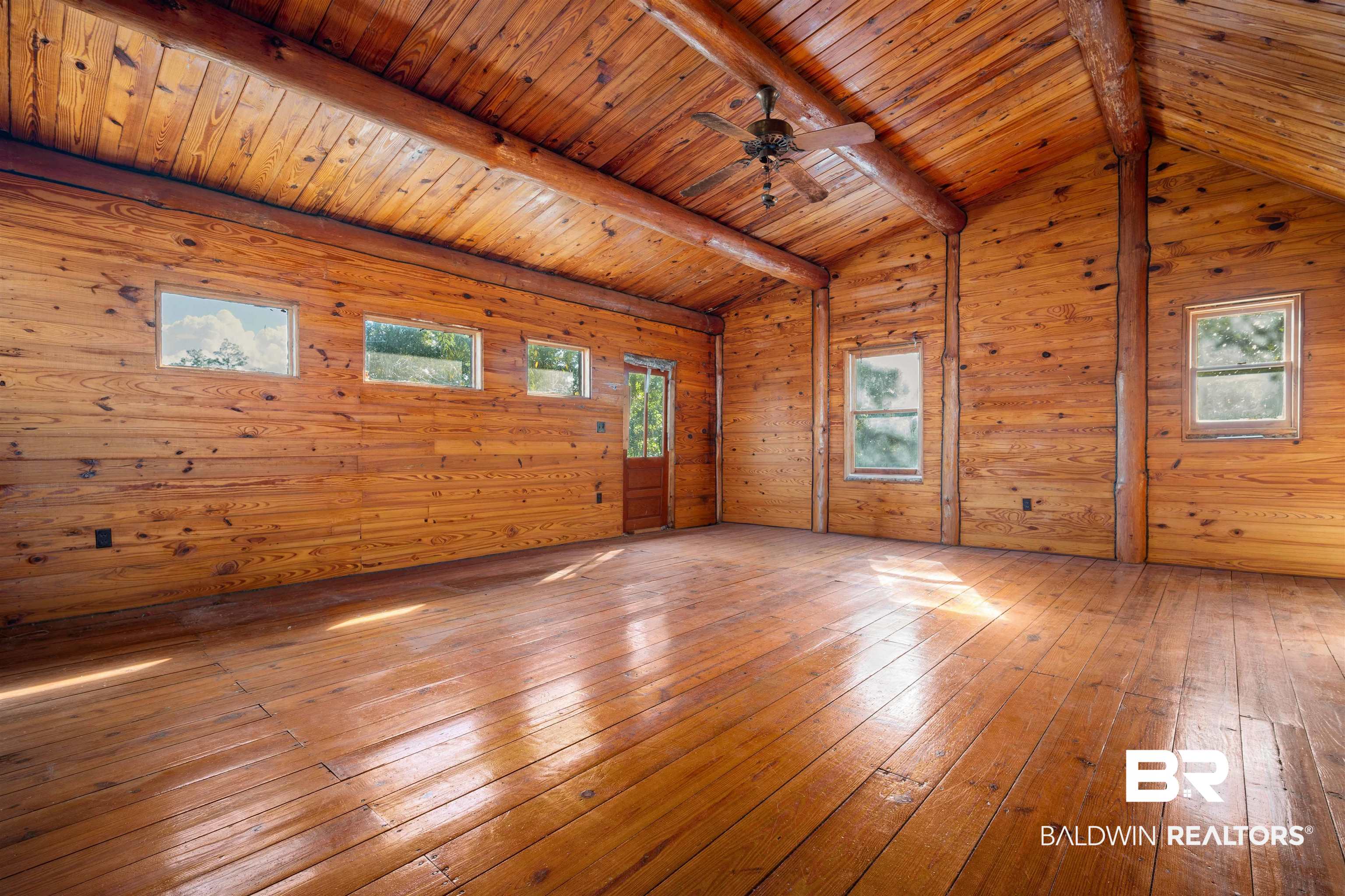 11236 Wren Avenue Fairhope, AL 36532 - Photo 14 of 35 Unfurnished room featuring wood walls, wood ceiling, hardwood / wood-style floors, ceiling fan, and plenty of natural light