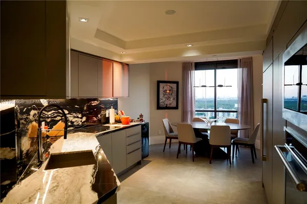 a view of a workspace with furniture and window
