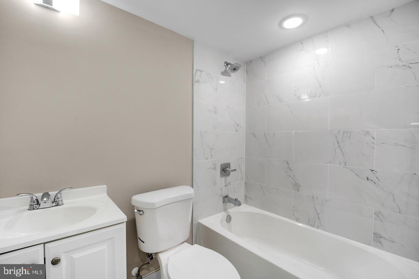 1617 Rhode Island Avenue Northeast, Unit 102 Washington, DC 20018 - Photo 12 of 17 a bathroom with a sink mirror toilet and bathtub