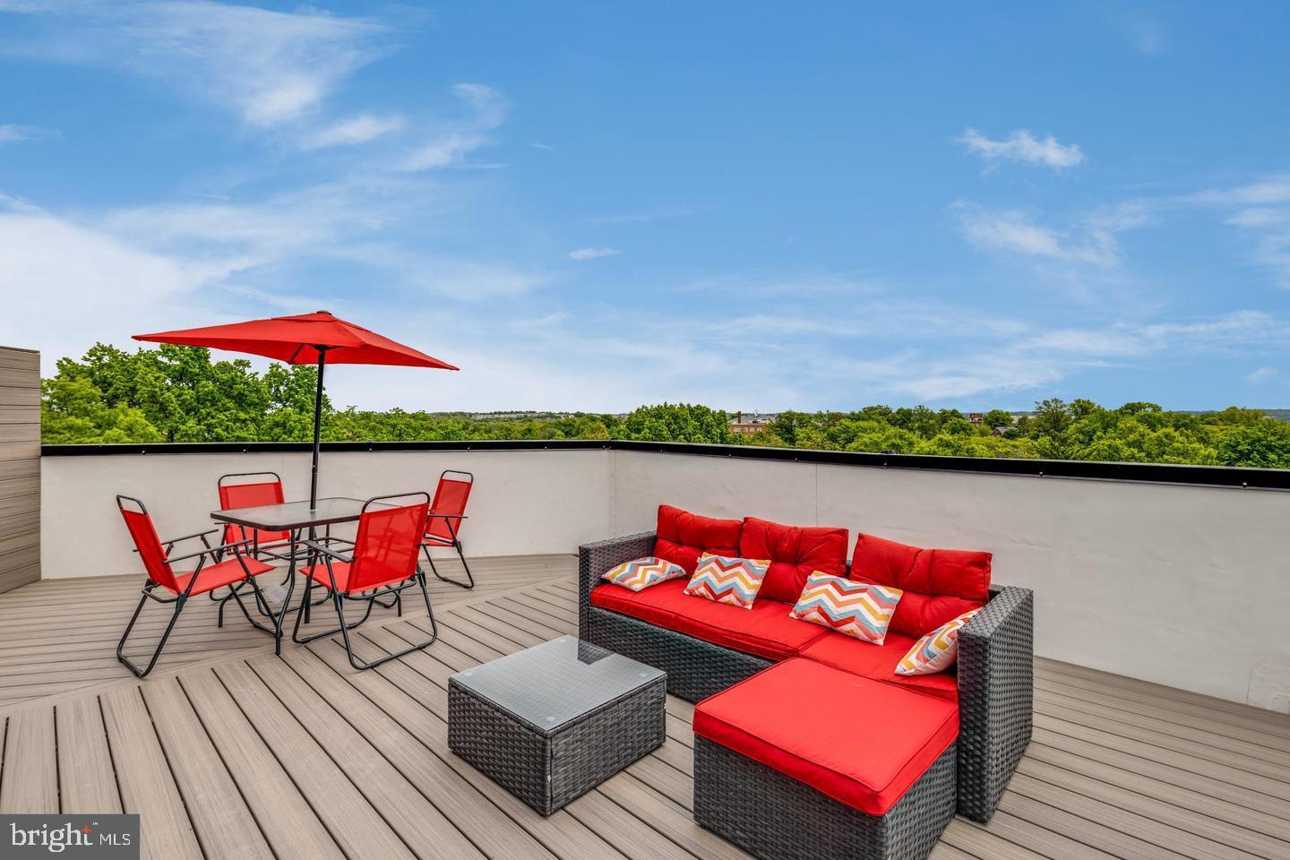 1617 Rhode Island Avenue Northeast, Unit 102 Washington, DC 20018 - Photo 14 of 17 an outdoor sitting area with furniture and umbrella