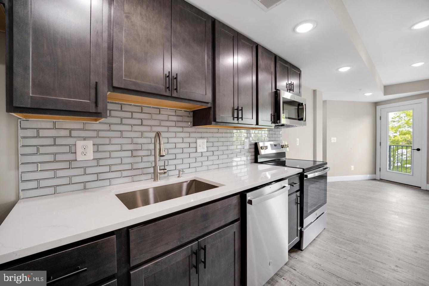 1617 Rhode Island Avenue Northeast, Unit 102 Washington, DC 20018 - Photo 4 of 17 a kitchen with a sink and cabinets