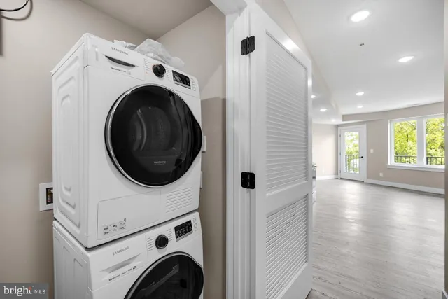 a view of a kitchen with refrigerator and a sink