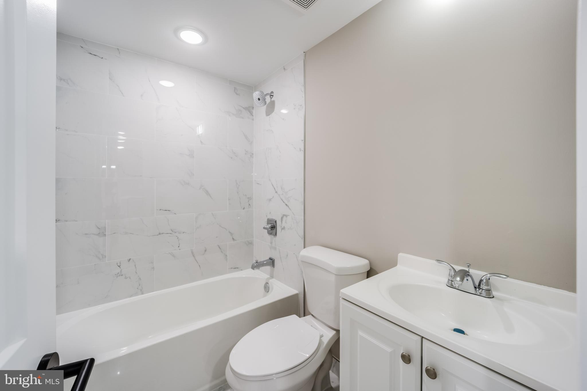 1617 Rhode Island Avenue Northeast, Unit 102 Washington, DC 20018 - Photo 9 of 17 a bathroom with a sink toilet and shower