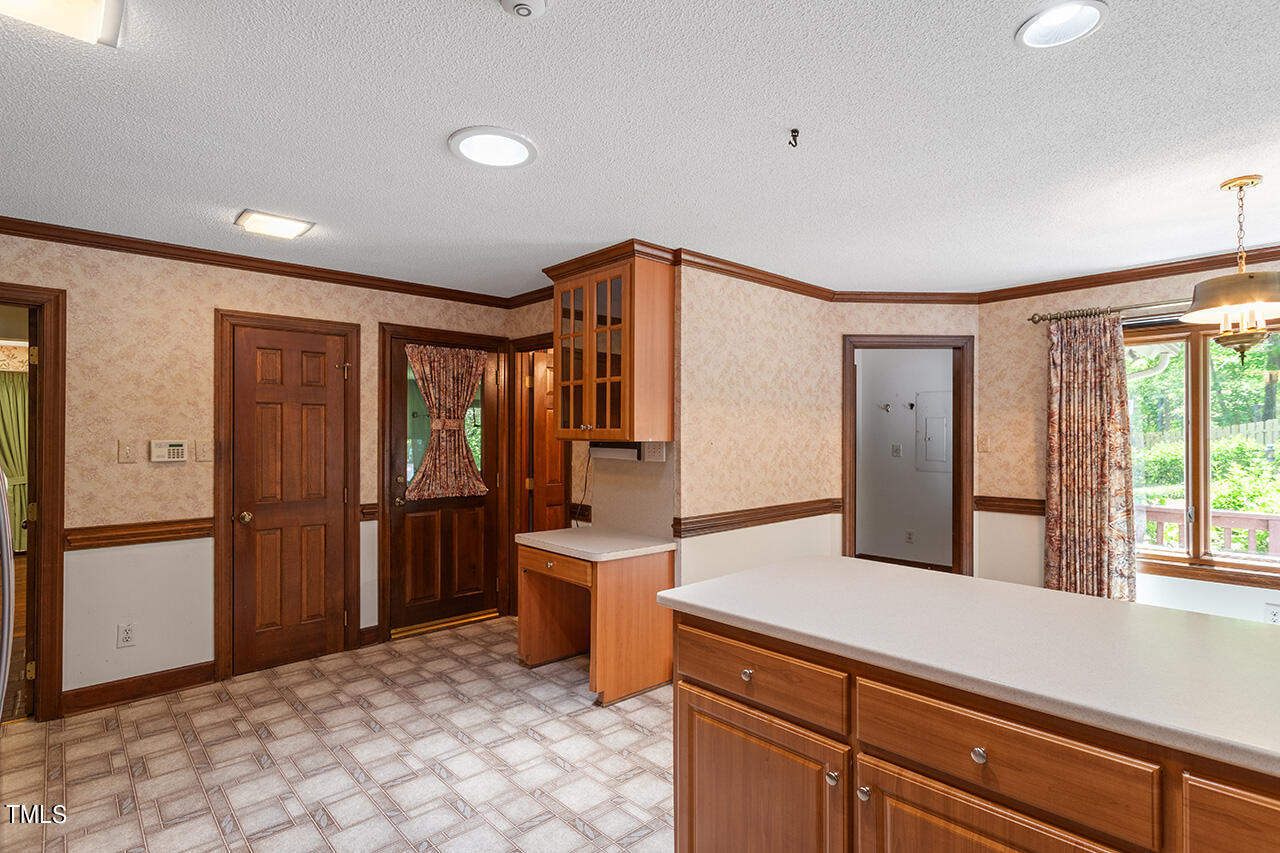 8845 Woodyhill Road Raleigh, NC 27613 - Photo 15 of 34 a kitchen with stainless steel appliances granite countertop a refrigerator and a sink