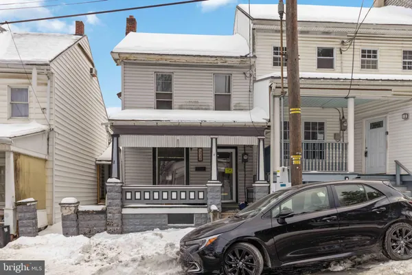 a front view of a house with parking space