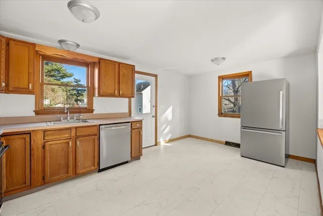 a kitchen with stainless steel appliances a refrigerator and a stove top oven