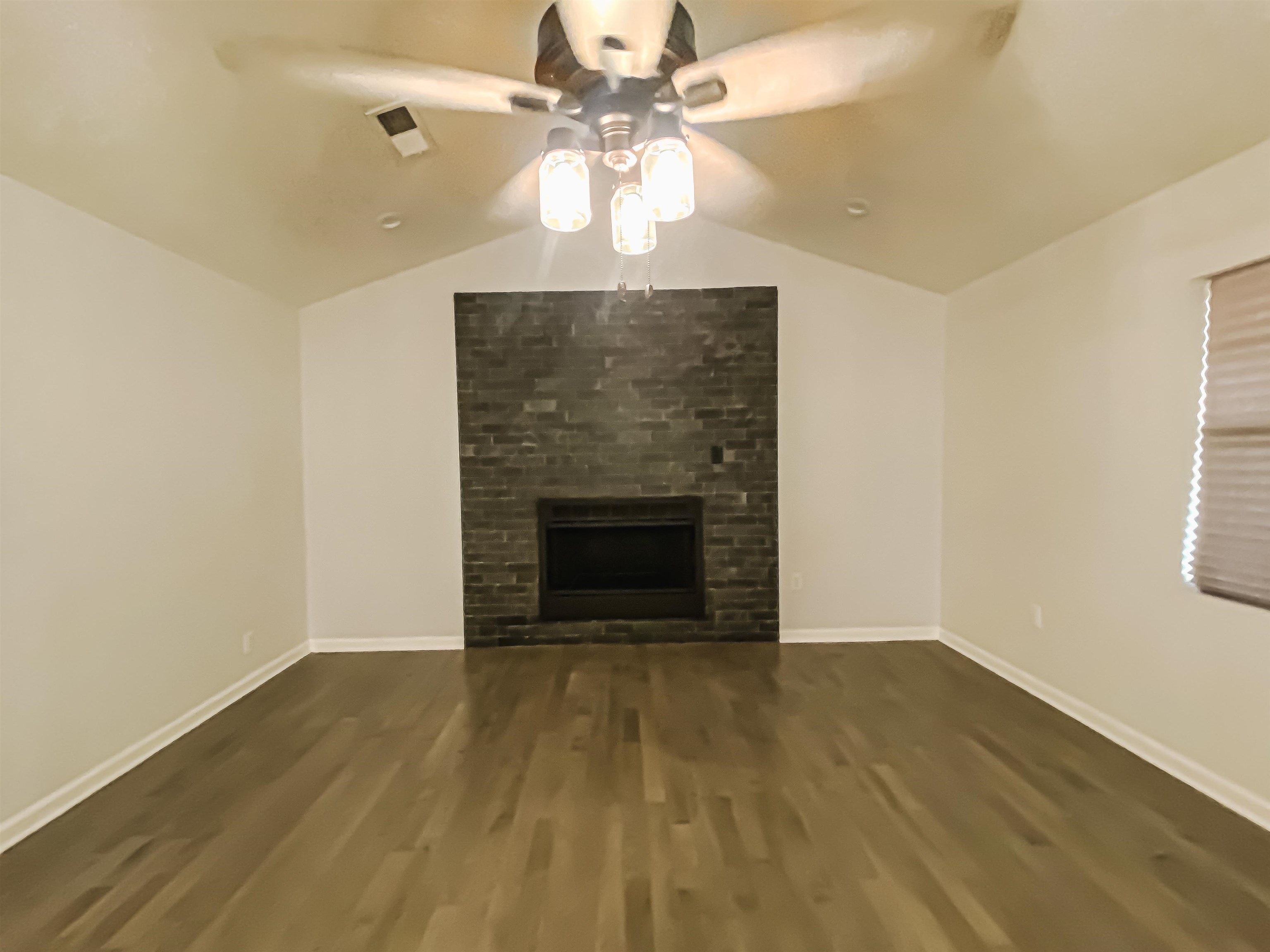 157 Pickett Road Memphis, TN 38109 - Photo 4 of 24 wooden floor fireplace and window in an empty room