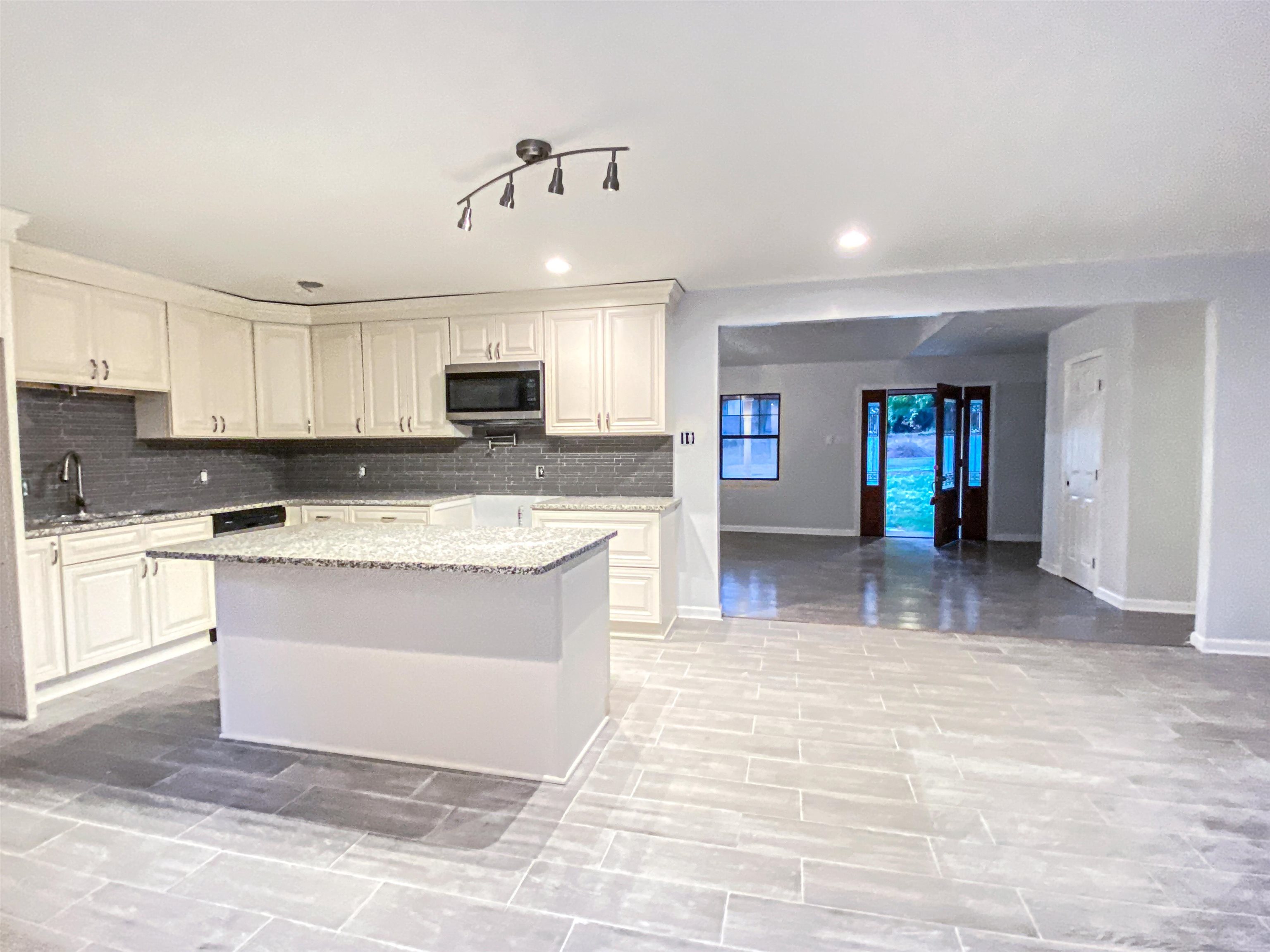 157 Pickett Road Memphis, TN 38109 - Photo 7 of 24 a large kitchen with granite countertop a stove top oven a sink a counter space and cabinets