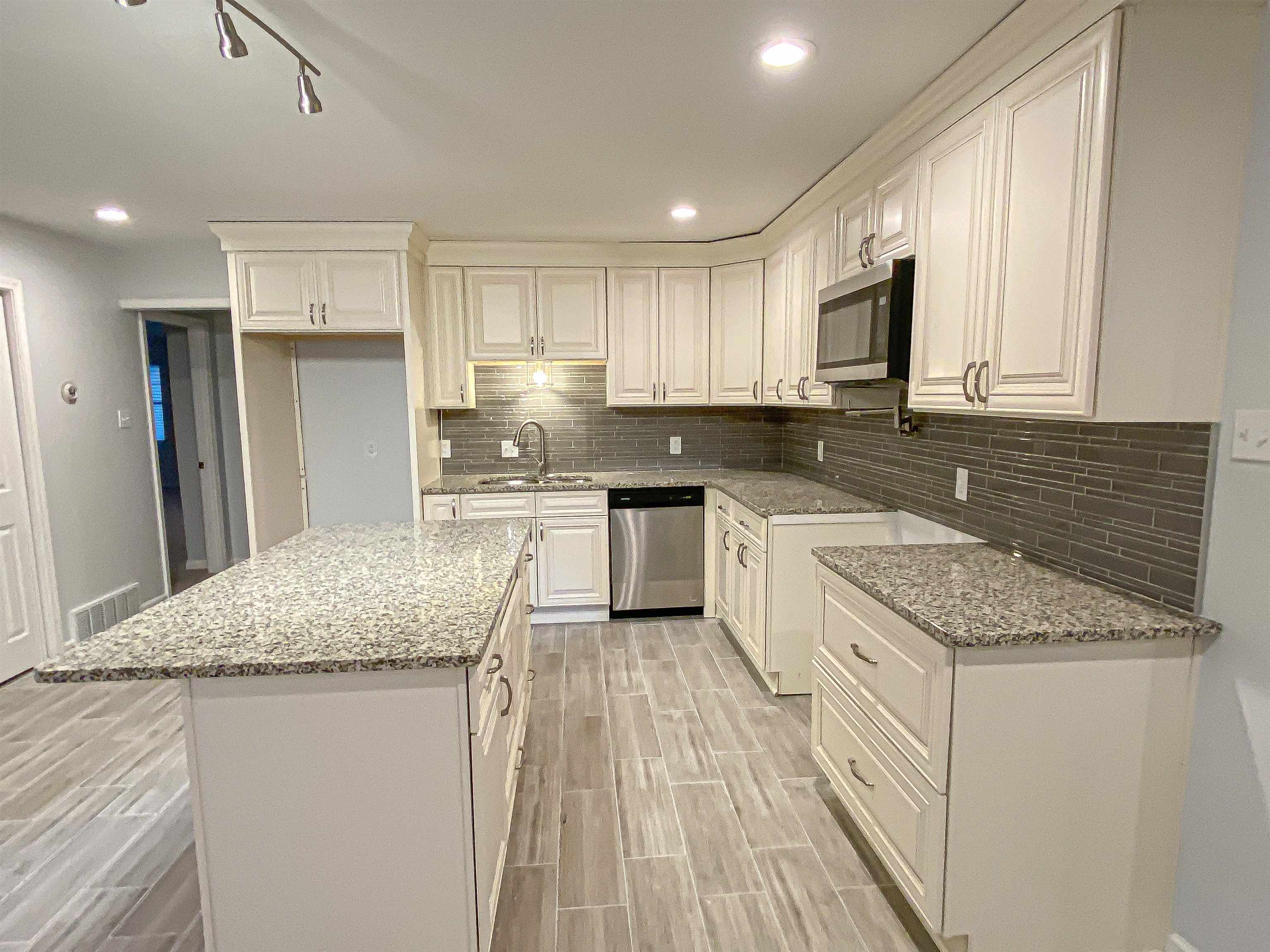 157 Pickett Road Memphis, TN 38109 - Photo 9 of 24 a kitchen with stainless steel appliances granite countertop a sink stove and cabinets