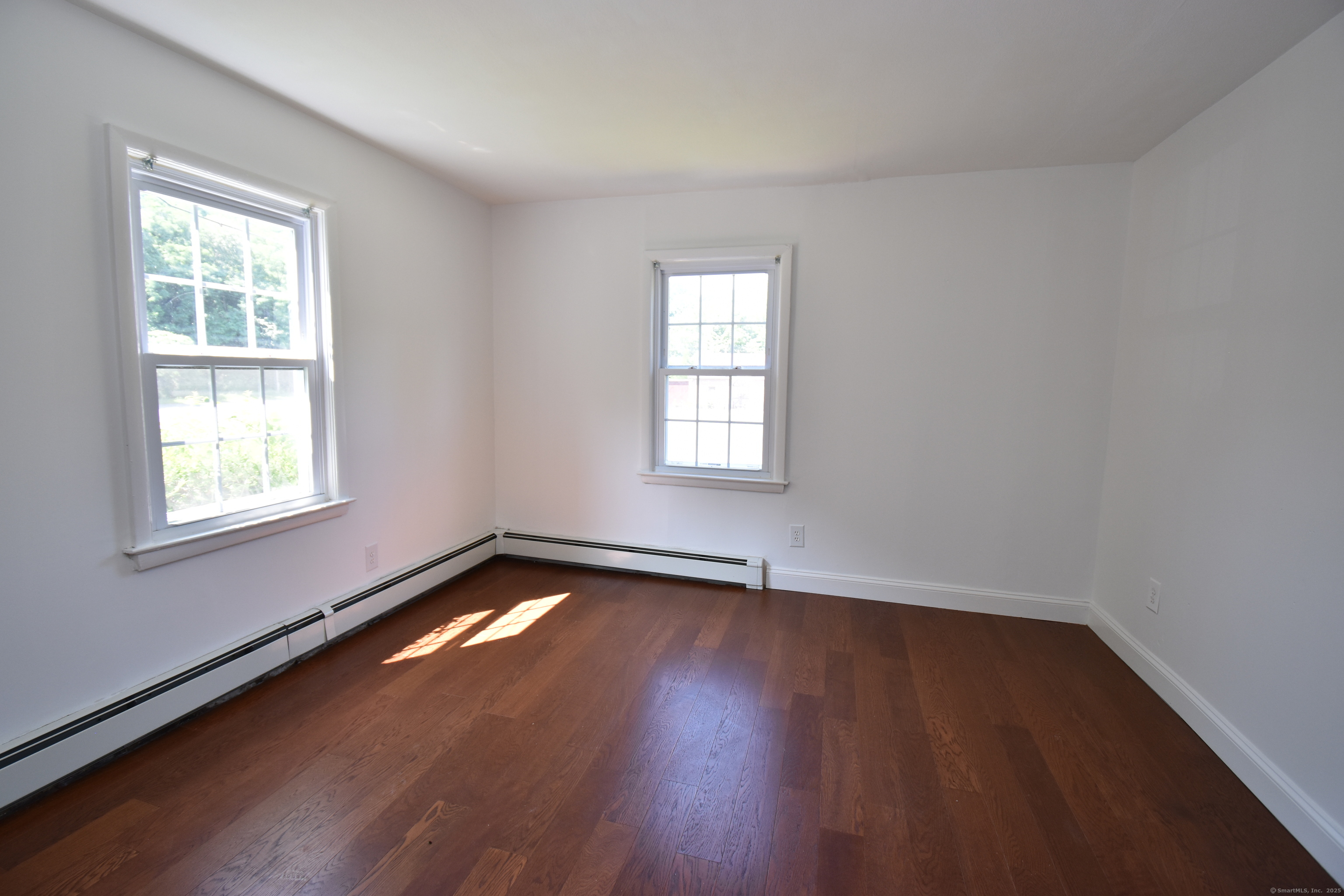 1197 Prospect Road Prospect, CT 06712 - Photo 14 of 21 an empty room with wooden floor and windows