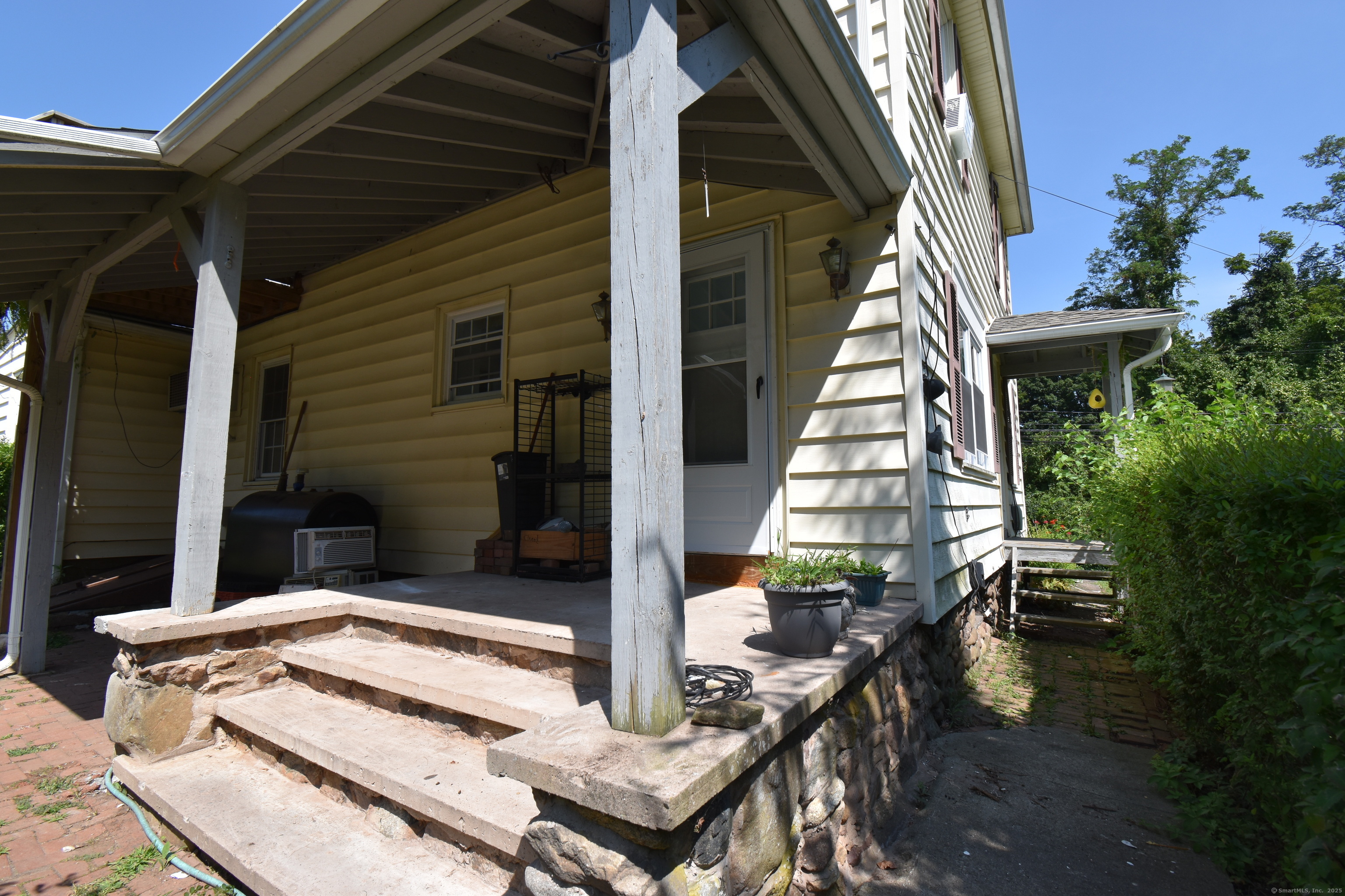1197 Prospect Road Prospect, CT 06712 - Photo 17 of 21 a view of house with a large windows and flower plants