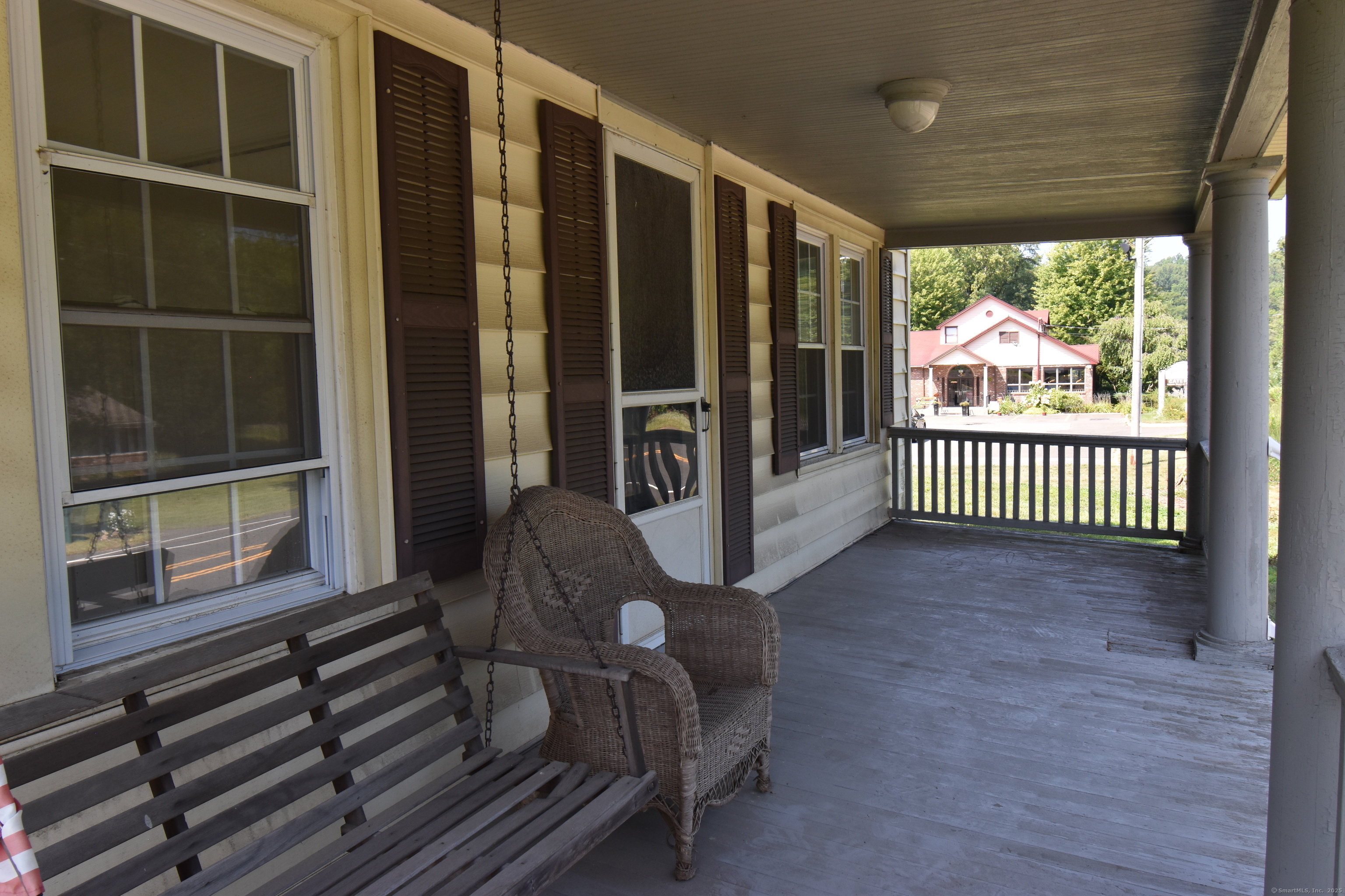 1197 Prospect Road Prospect, CT 06712 - Photo 2 of 21 a view of a porch with wooden floor and iron stairs