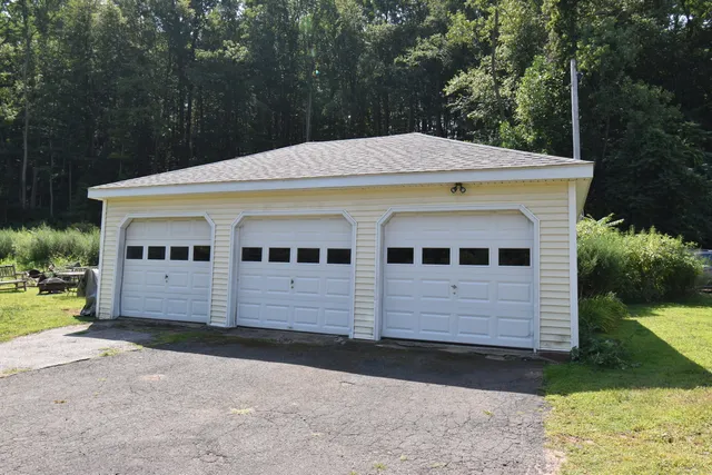 a view of a white house with a yard