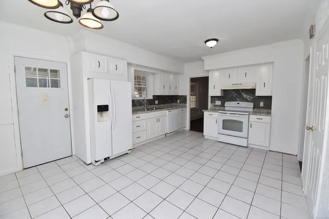 a kitchen with cabinets and steel stainless steel appliances