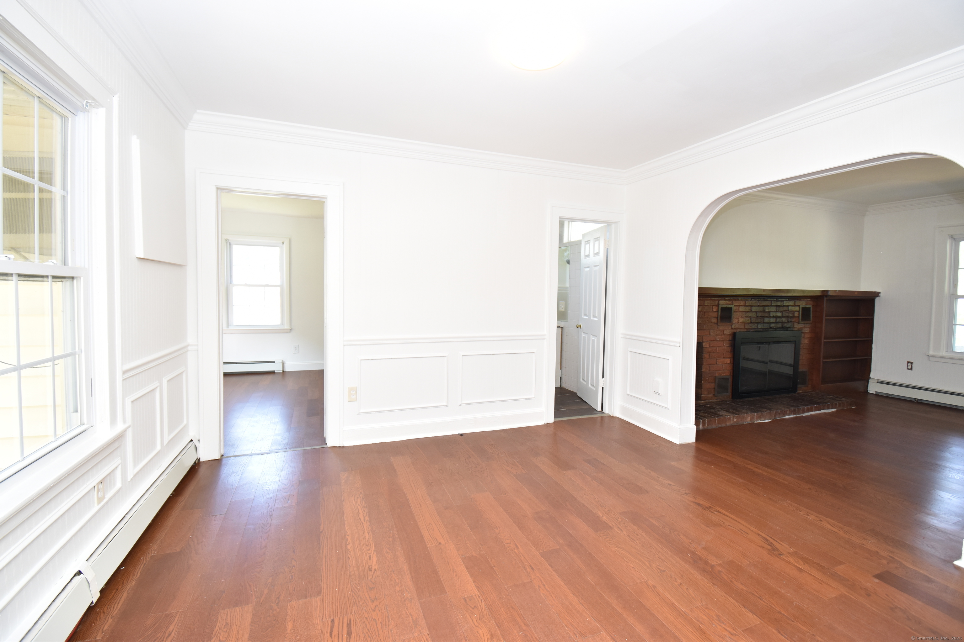 1197 Prospect Road Prospect, CT 06712 - Photo 10 of 21 a view of empty room with wooden floor and fireplace