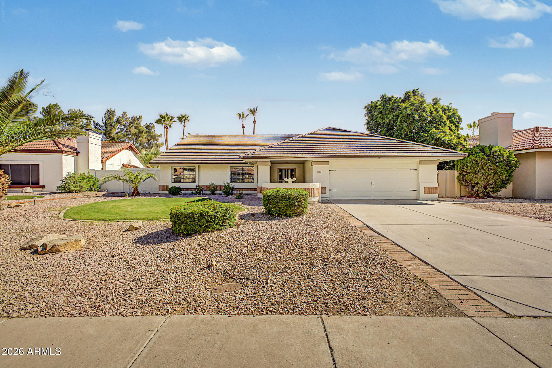 6725 West Utopia Road Glendale, AZ 85308 - Photo 1 of 27 a house with green field in front of it