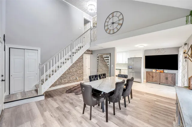 a view of a a dining room with furniture window and wooden floor