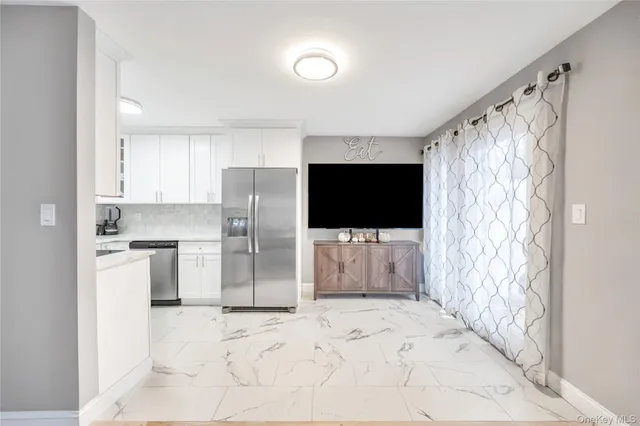 a view of a kitchen with a sink and a refrigerator