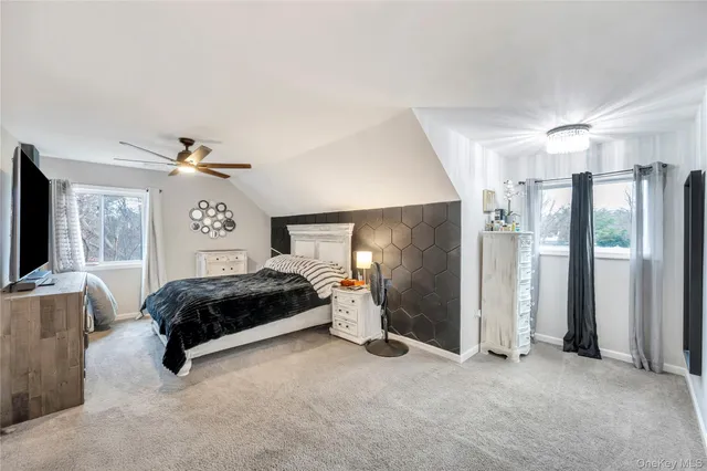 a bedroom with a bed couch and window