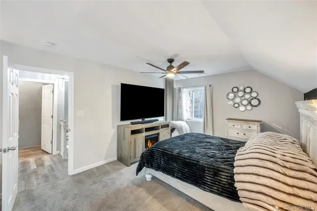 a bedroom with a large bed and a flat screen tv