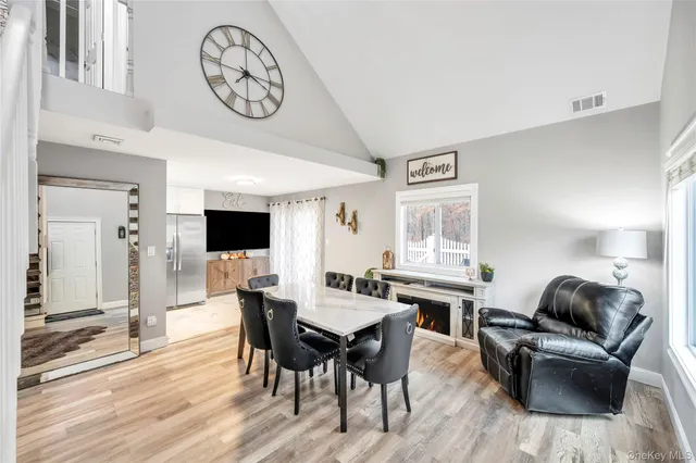 a view of a dining room with furniture window and wooden floor