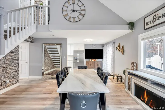 a living room with furniture a flat screen tv and a clock