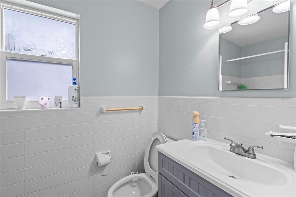 2343 Prospect Street Sarasota, FL 34239 - Photo 11 of 33 a bathroom with a toilet a sink a mirror and vanity