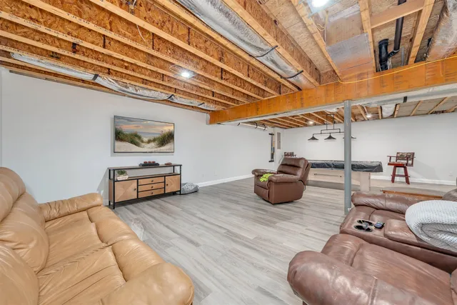 a room with pool table and windows