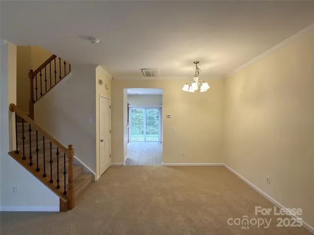 a view of an empty room with stairs