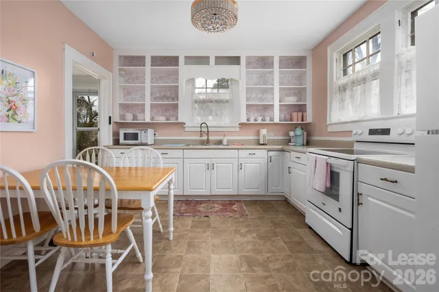 a kitchen with a stove a sink and a refrigerator