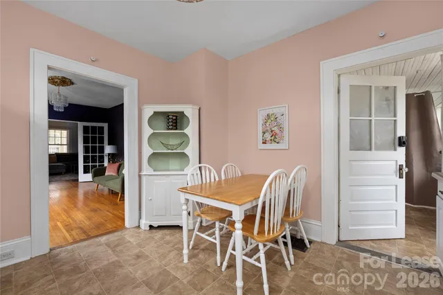 a dining room with furniture and window