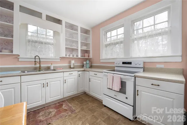 a kitchen that has a sink and a stove in it