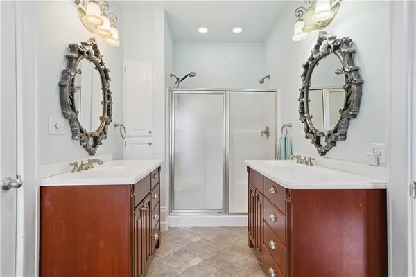 a bathroom with a sink a mirror a vanity and shower