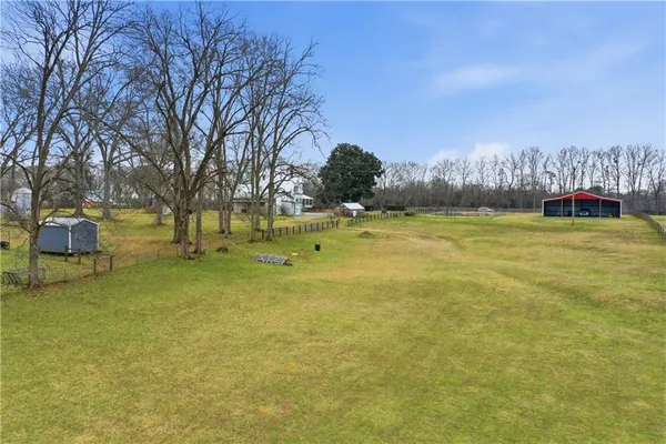 a view of a yard with swimming pool