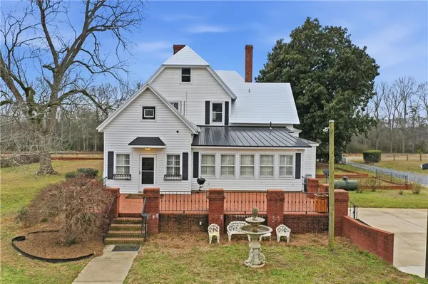 a aerial view of a house with swimming pool and sitting area