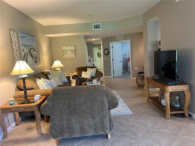 a dining room with furniture a window and a kitchen