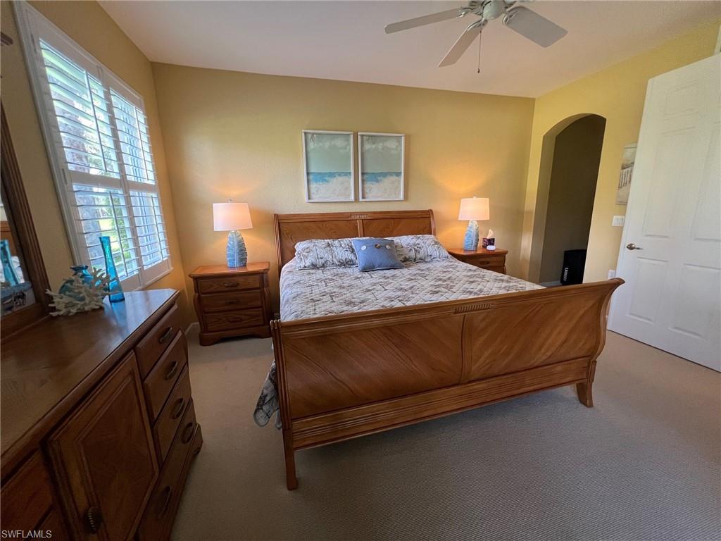 6864 Ascot Drive, Unit 101 Naples, FL 34113 - Photo 15 of 40 a bedroom with a bed wooden floor and window