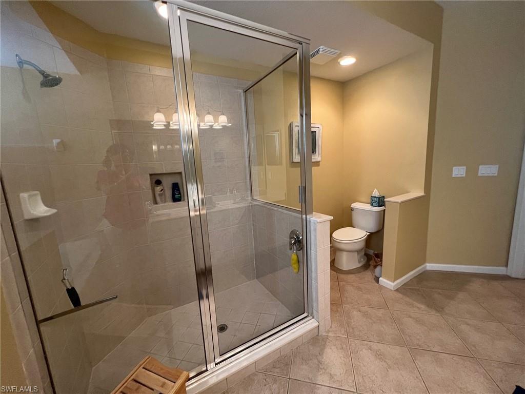 6864 Ascot Drive, Unit 101 Naples, FL 34113 - Photo 19 of 40 a bathroom with a shower and toilet