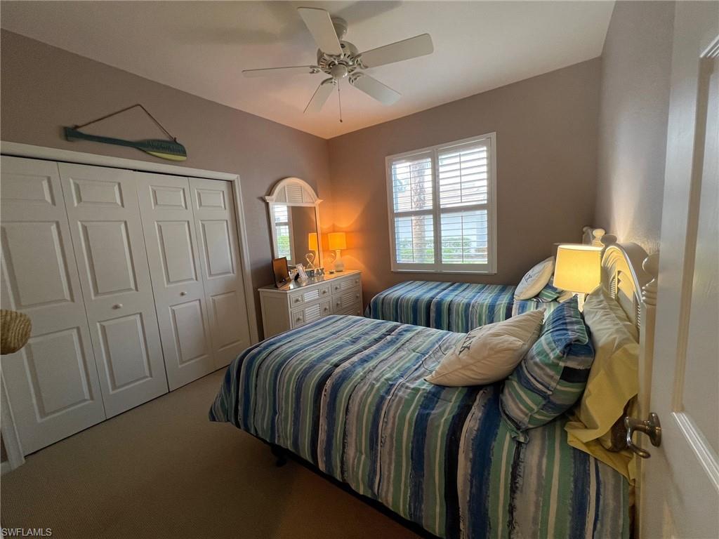 6864 Ascot Drive, Unit 101 Naples, FL 34113 - Photo 20 of 40 a bedroom with a bed and a window